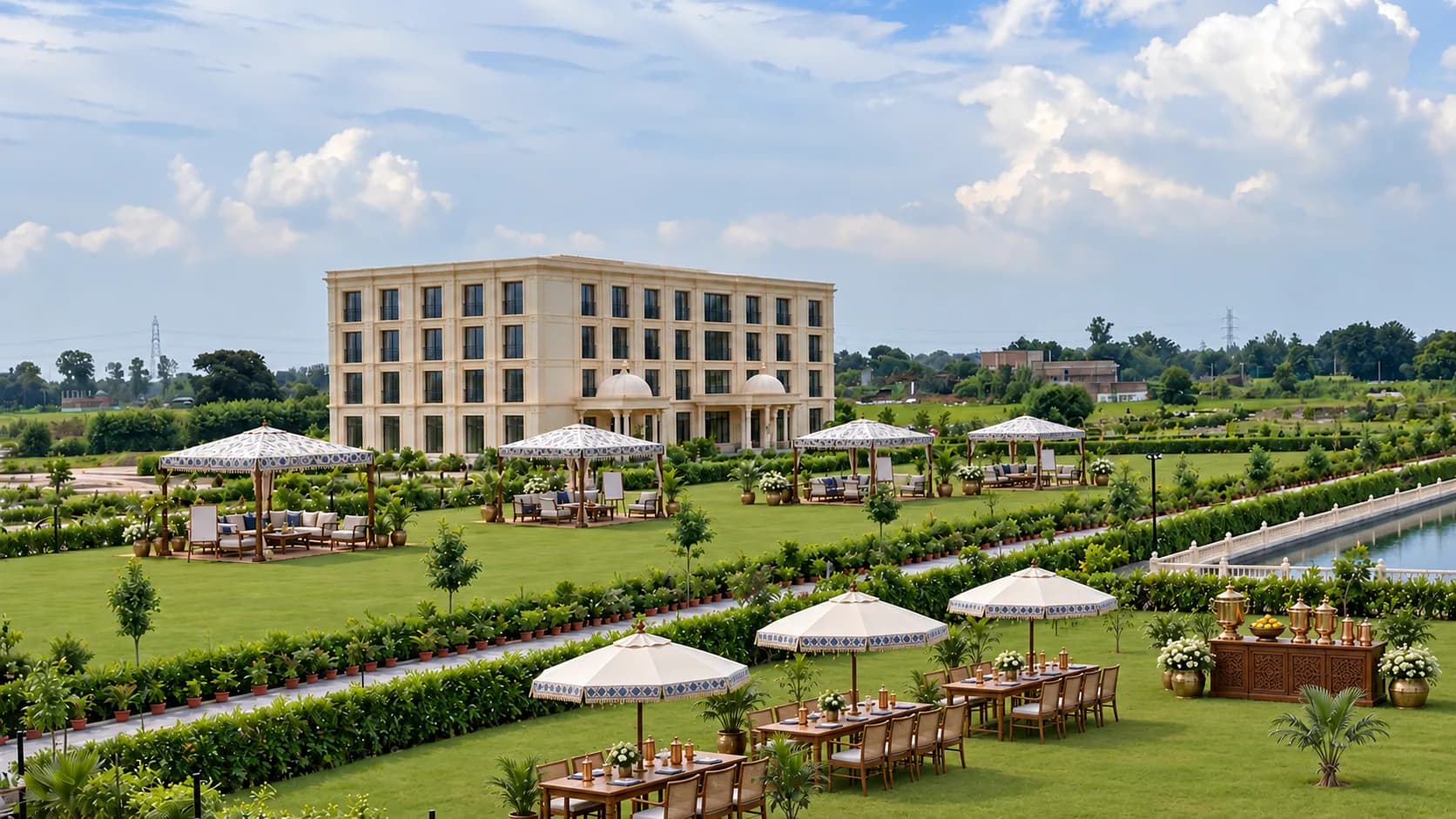 The lawn in front of the hotel by day, set with white umbrellas and long tables